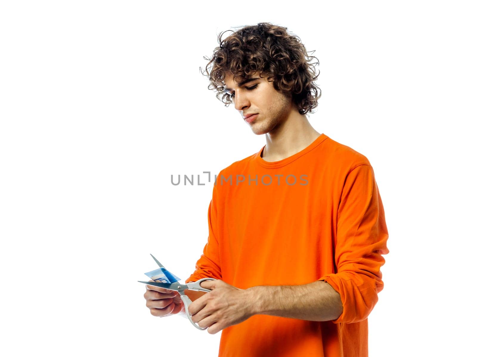 one young man caucasian happy holding credit card portrait  in studio white background