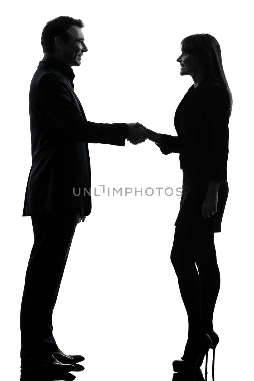 one caucasian couple business woman man in silhouette studio isolated on white background