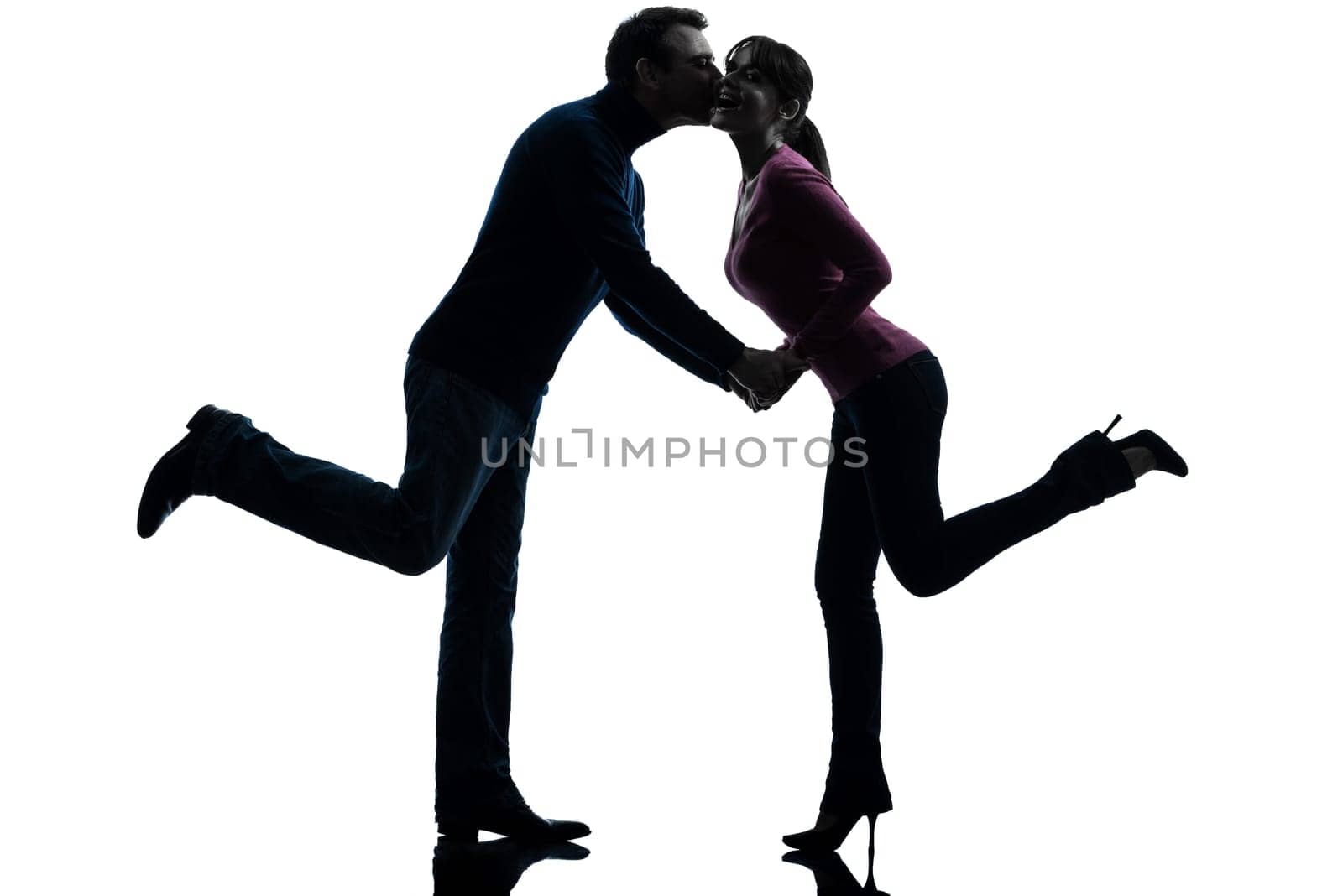 one caucasian couple woman man lovers kissing    in silhouette studio isolated on white background
