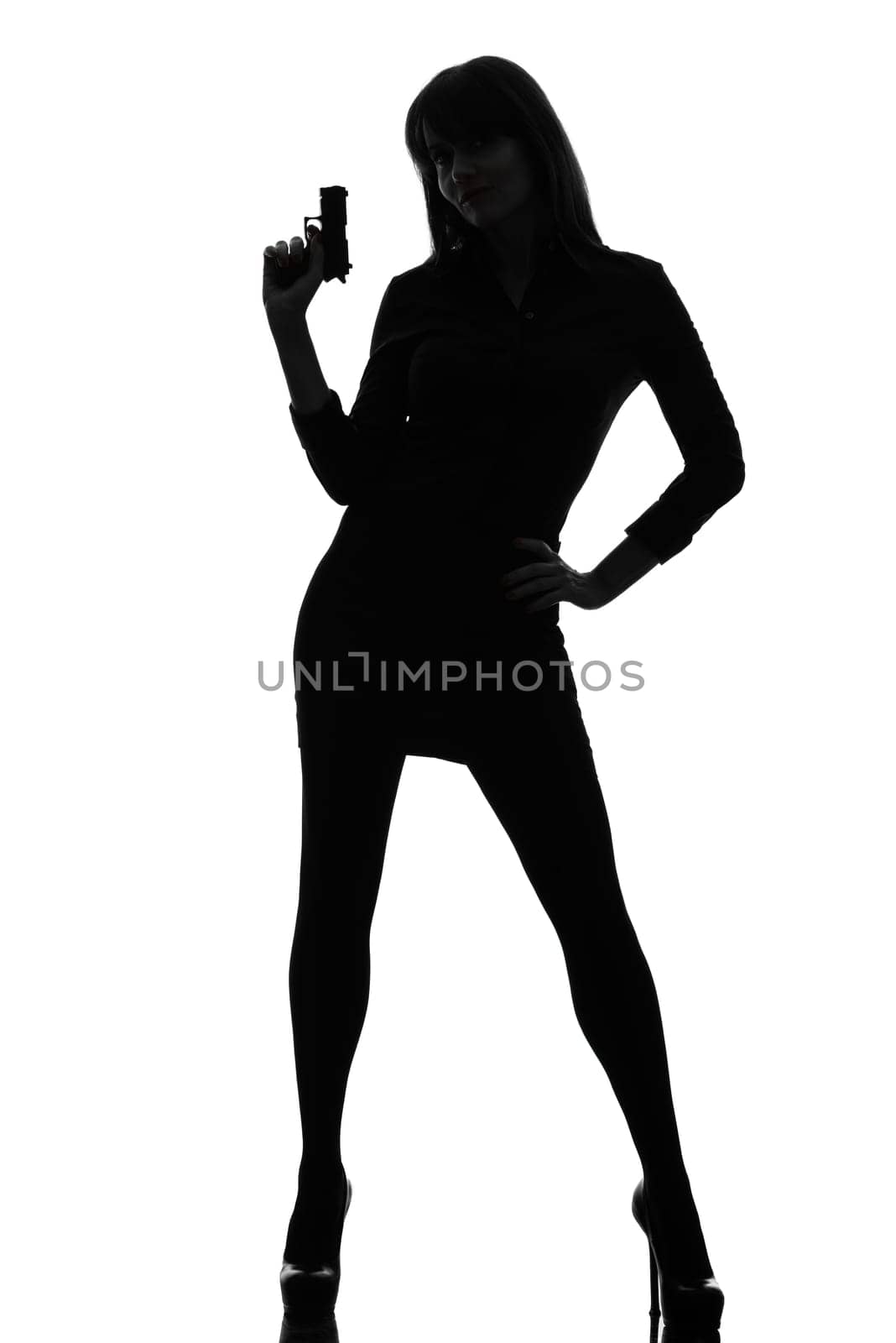 one caucasian sexy detective  woman holding aiming  gun in silhouette studio isolated on white background