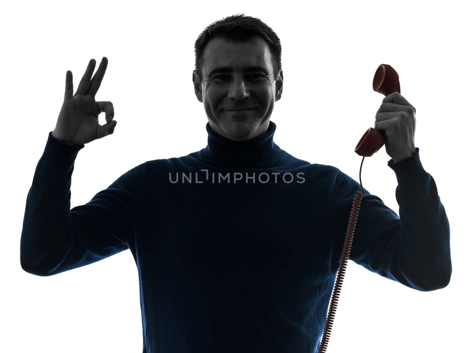 one causasian man on the phone ok sign portrait in silhouette studio isolated on white background