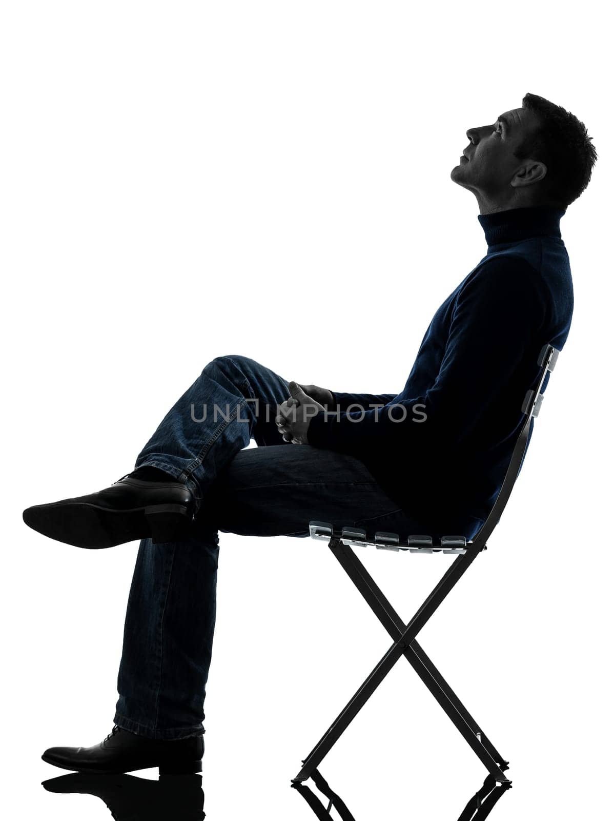one causasian man reading book full length in silhouette studio isolated on white background