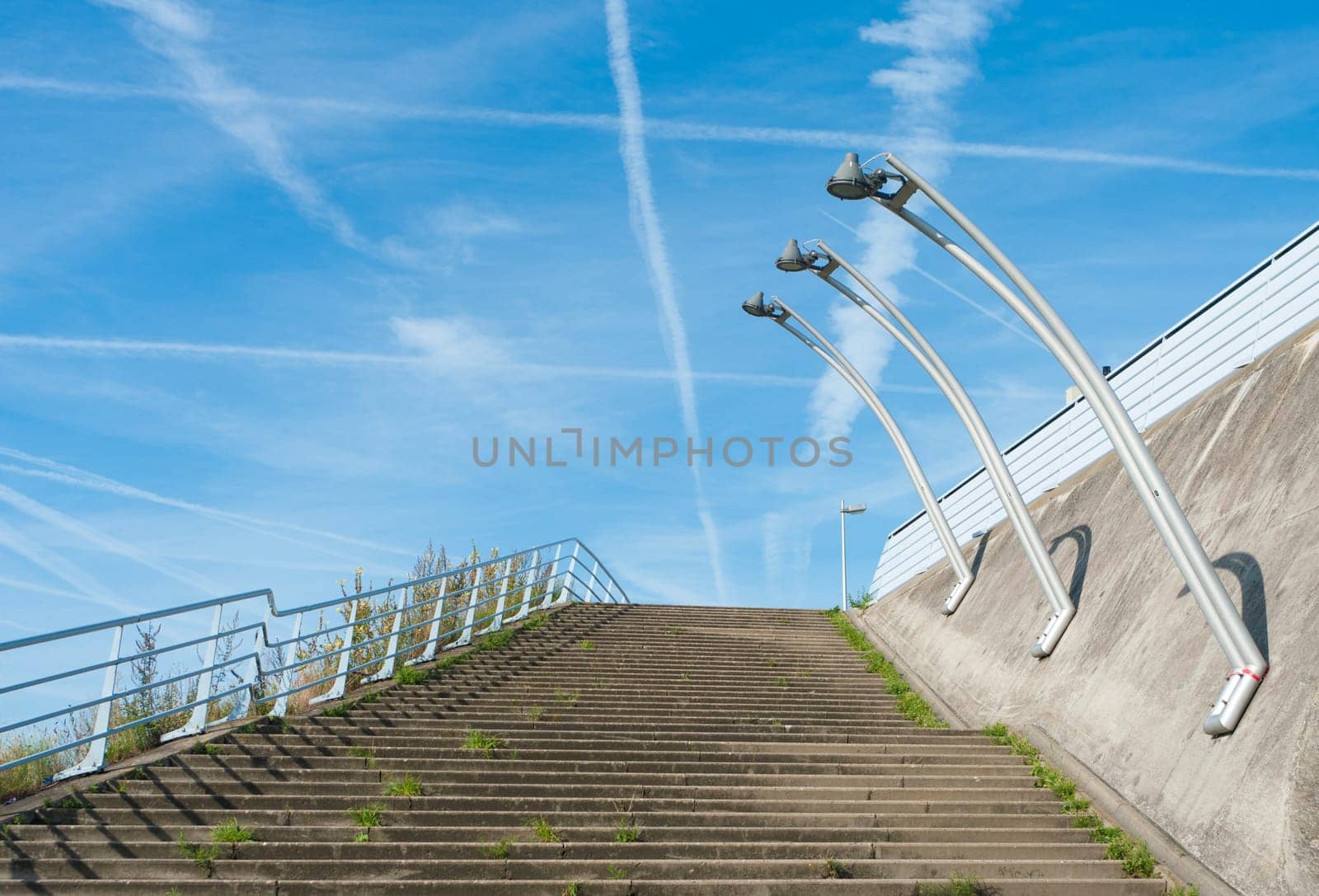 outside stairway with lampposts against a blue sky