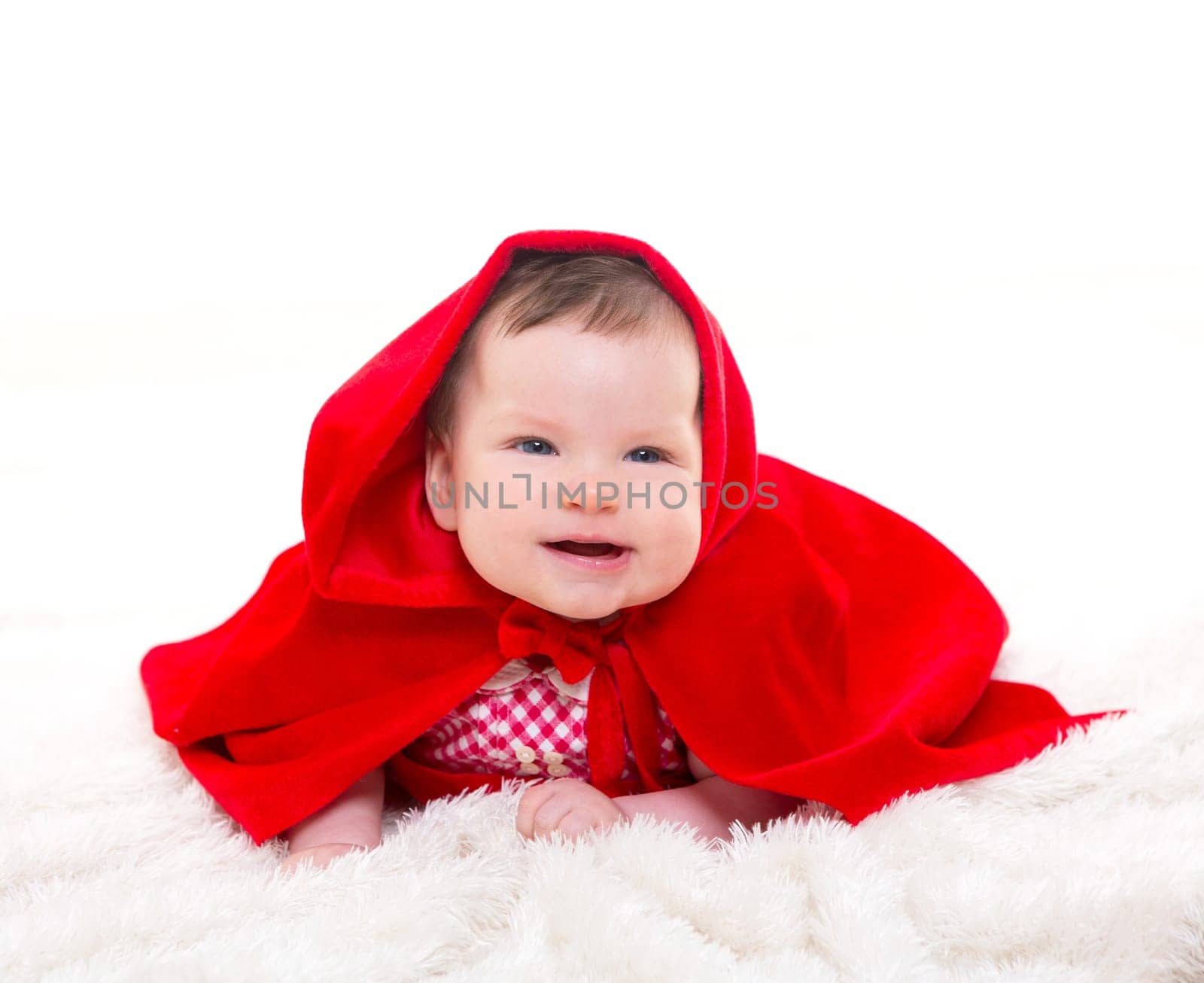 Baby Little Red Riding Hood on white fur with funny expression