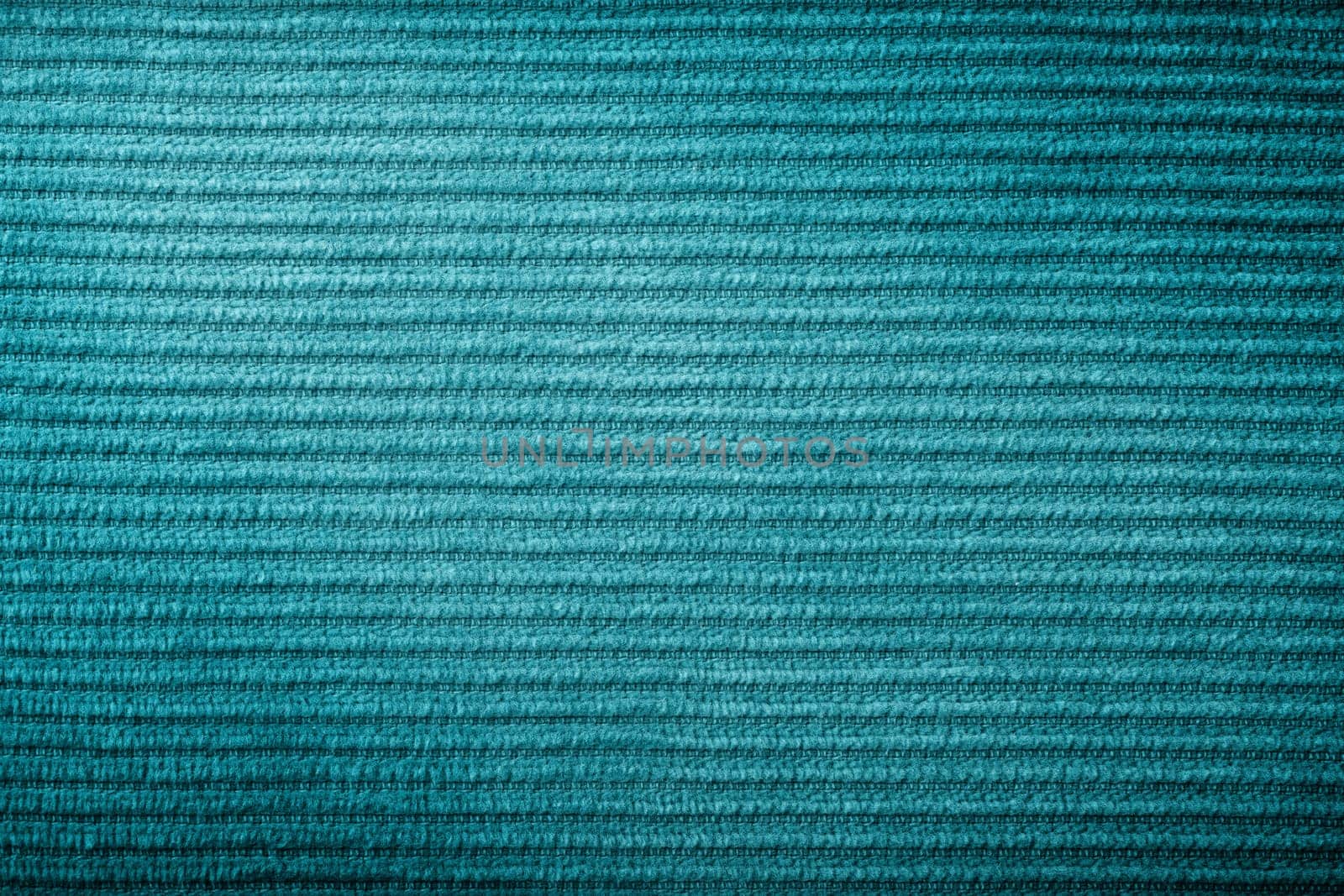Green corduroy fabric texture for background. Macro shot