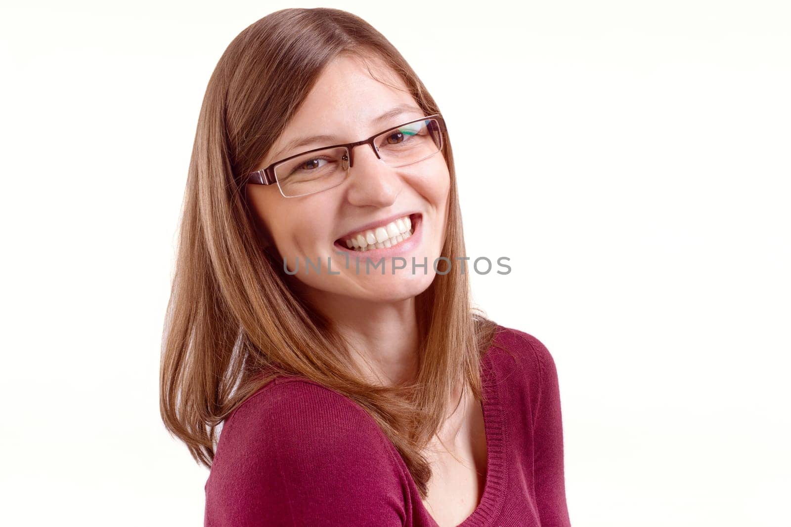 Happy young woman with spectacles, smiling at camera.