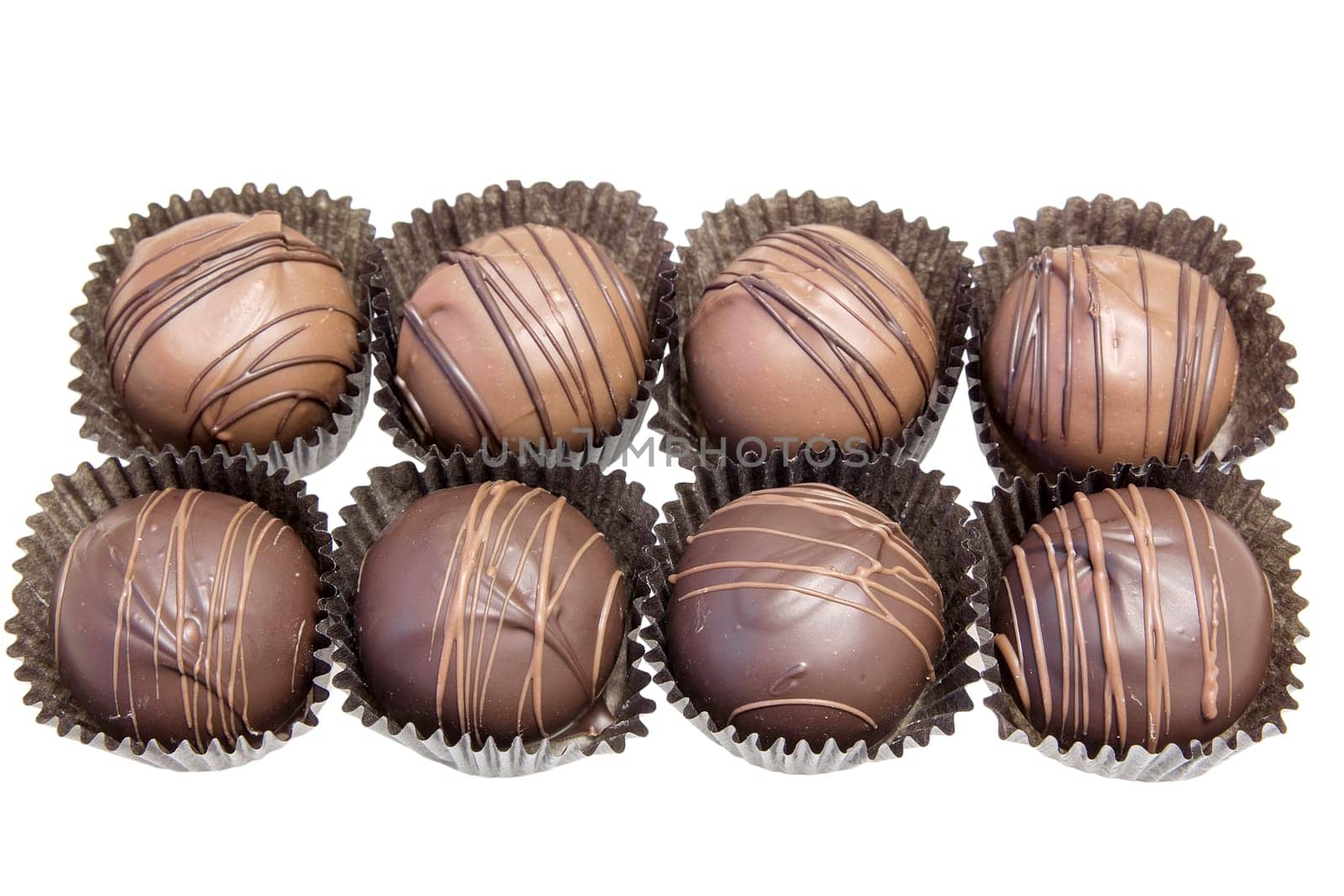 Group of Eight Dark and Milk Chocolate Truffles Bonbon Isolated on White Background