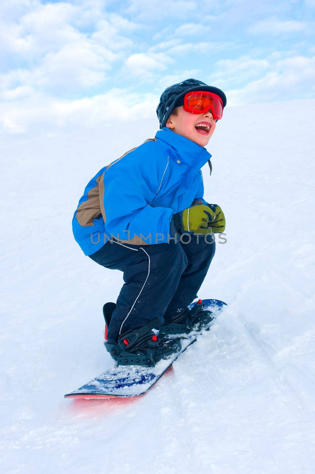 Boy is snowboarding