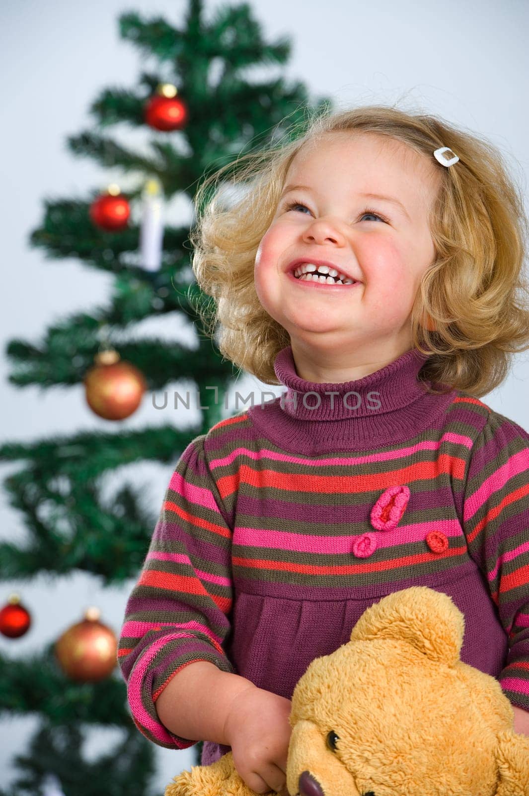 happy girl in front of christmas-tree