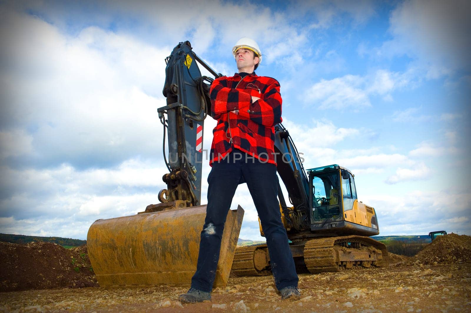 building worker in front of excavator