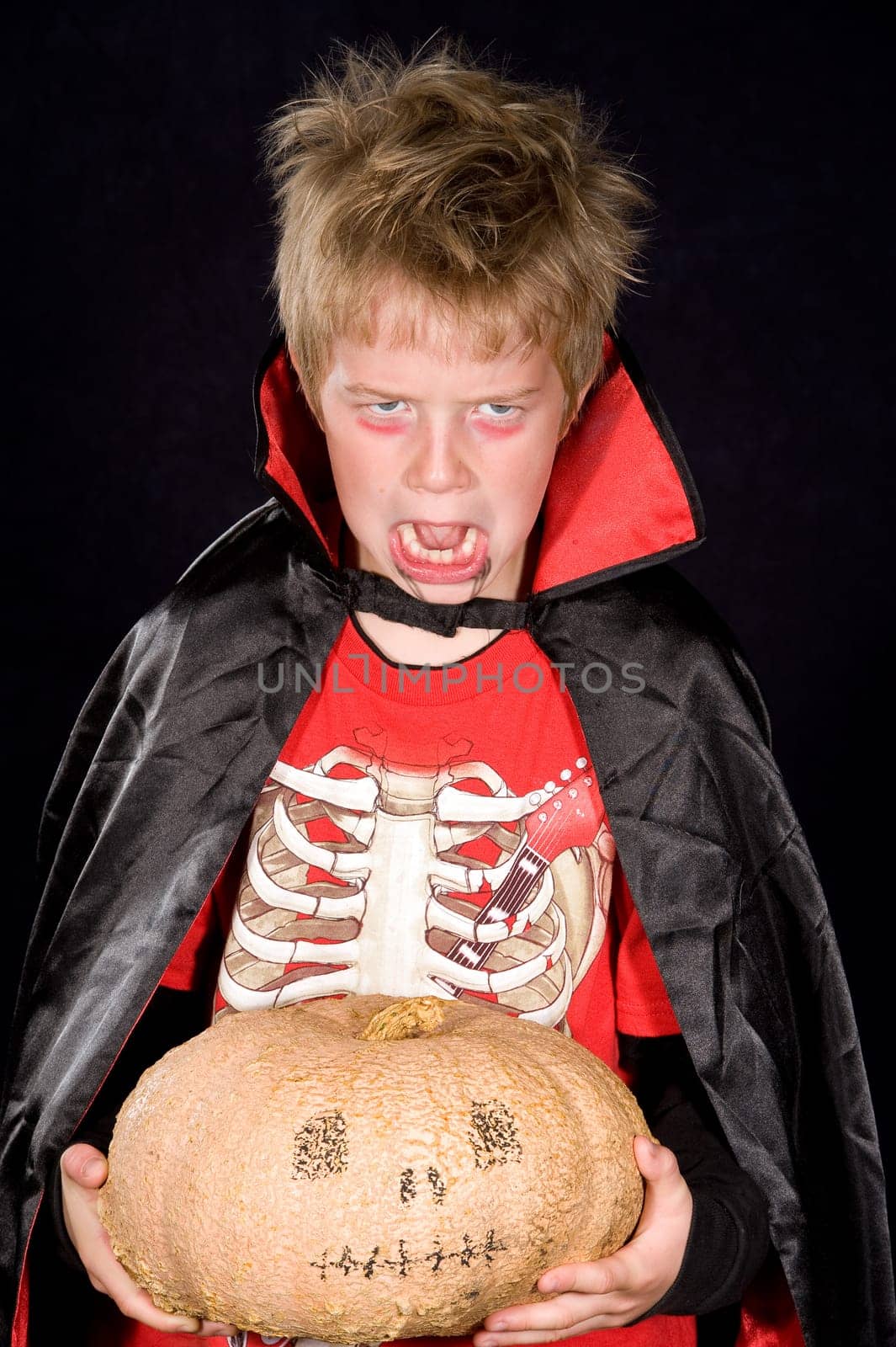 wild boy in halloween- outfit with pumpkin