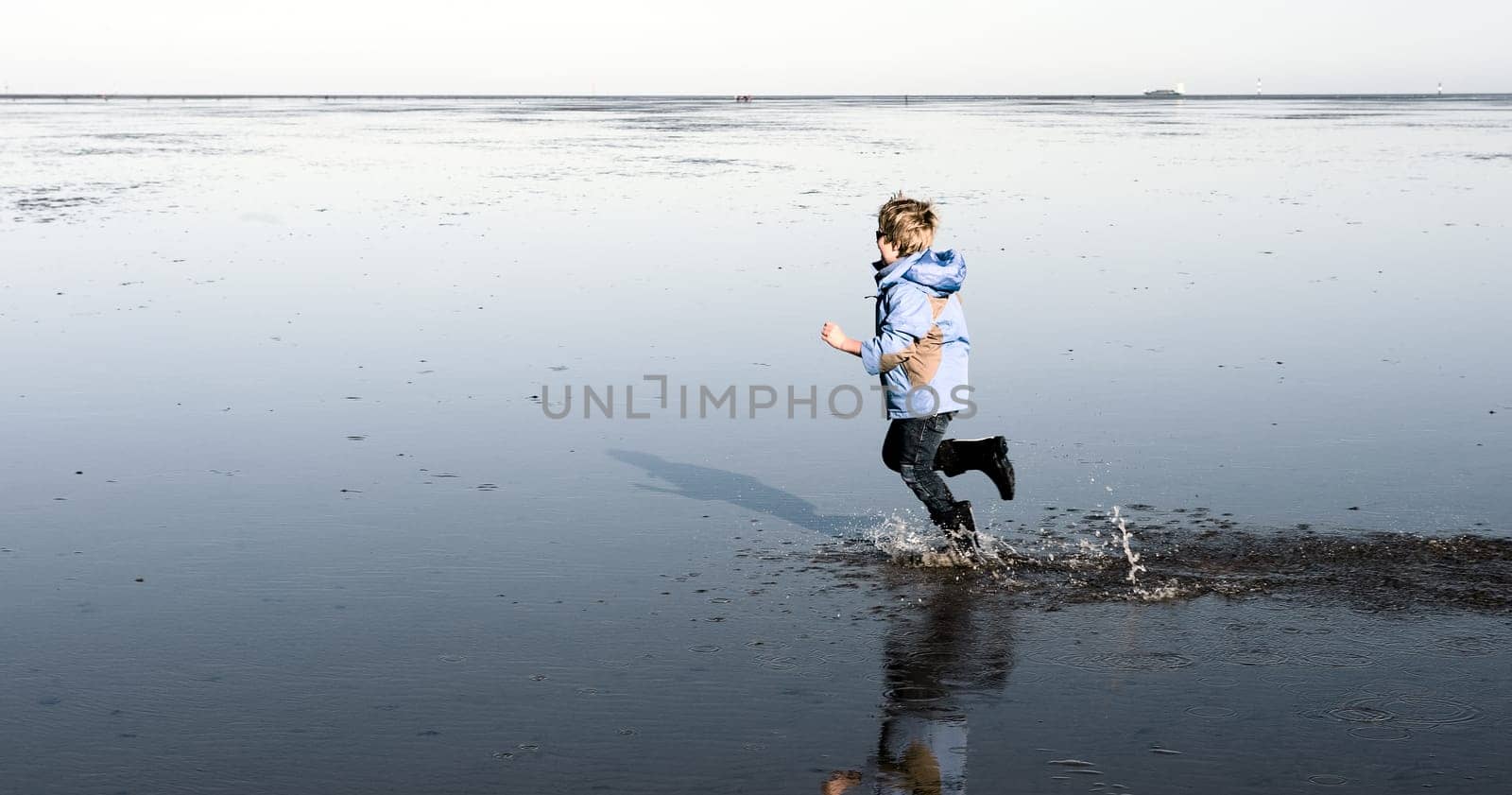 boy is running in the water
