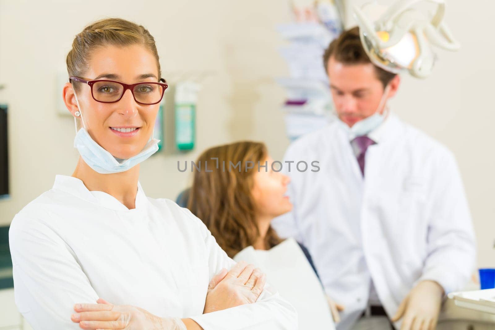 Practice,in the background a patient receives a treatment from a colleague