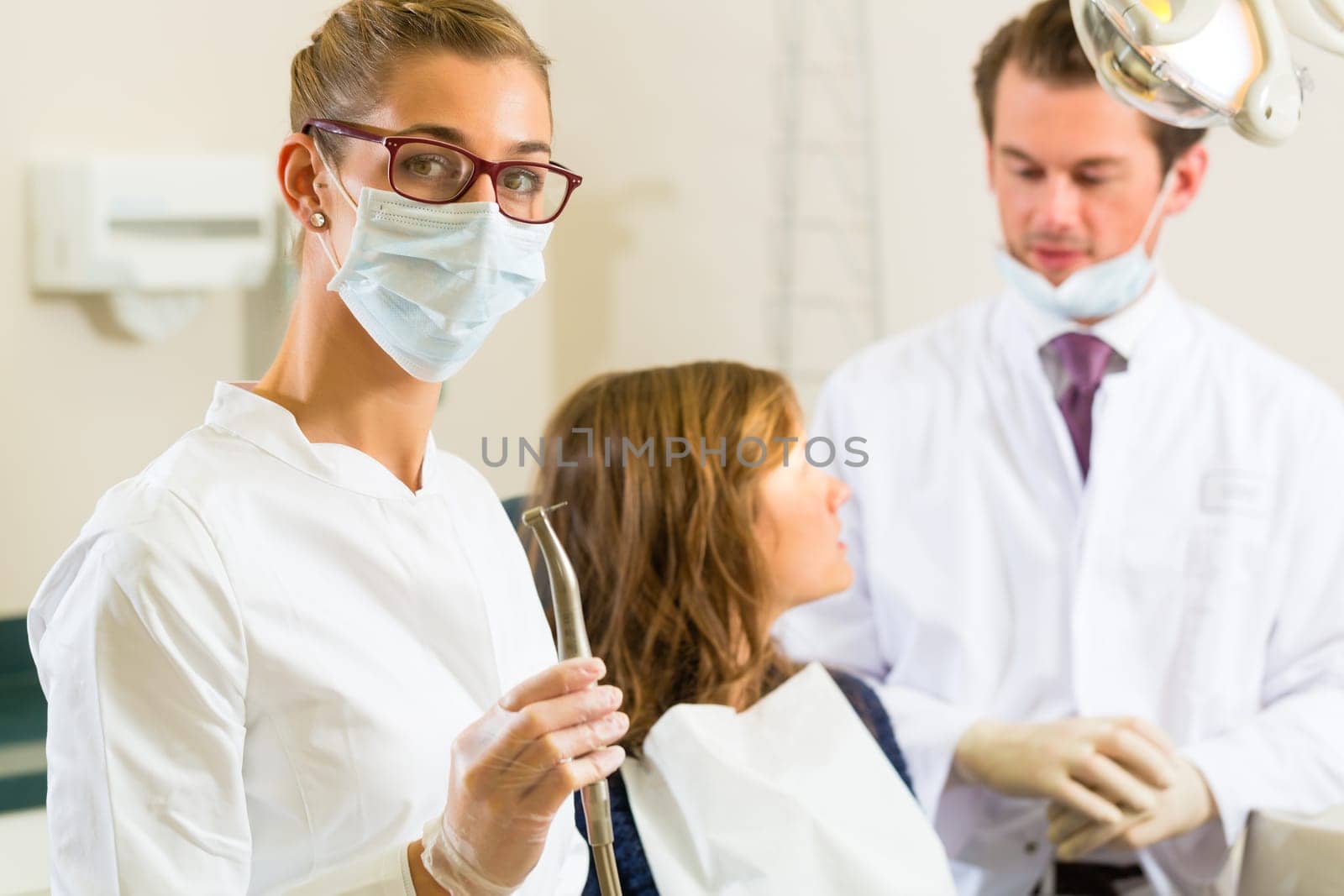 Practice,in the background a patient receives a treatment from a colleague