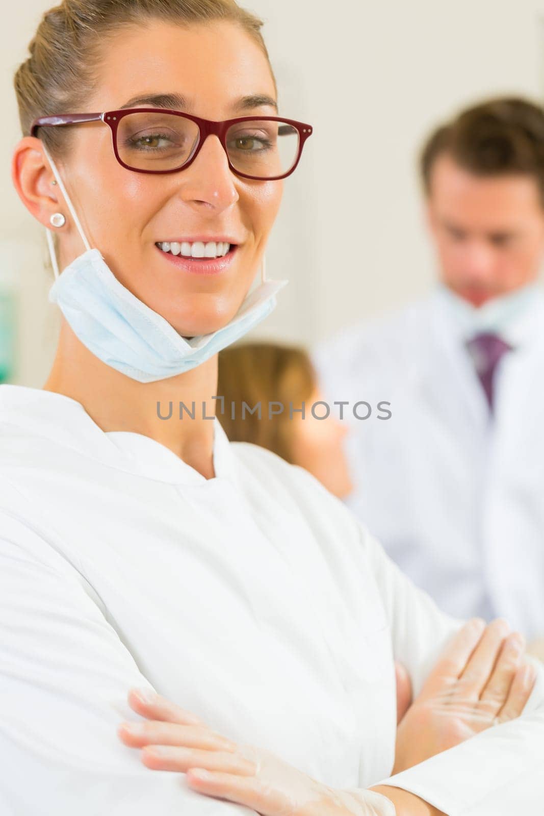Practice,in the background a patient receives a treatment from a colleague
