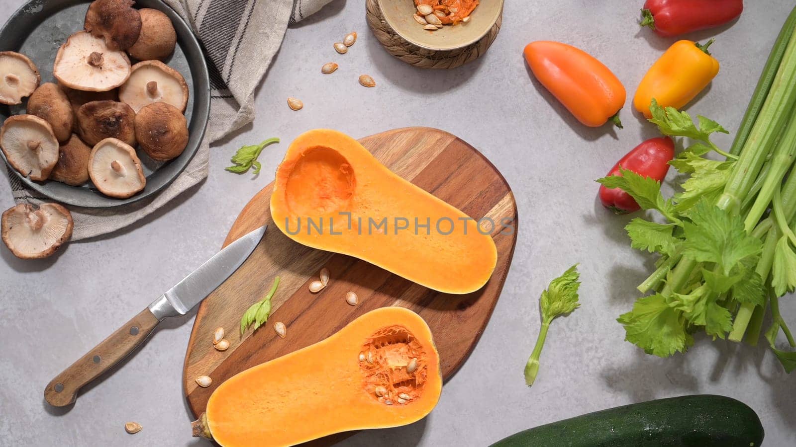 Autumn vegetables arranged on a kitchen worktop while preparing a pumpkin soup.