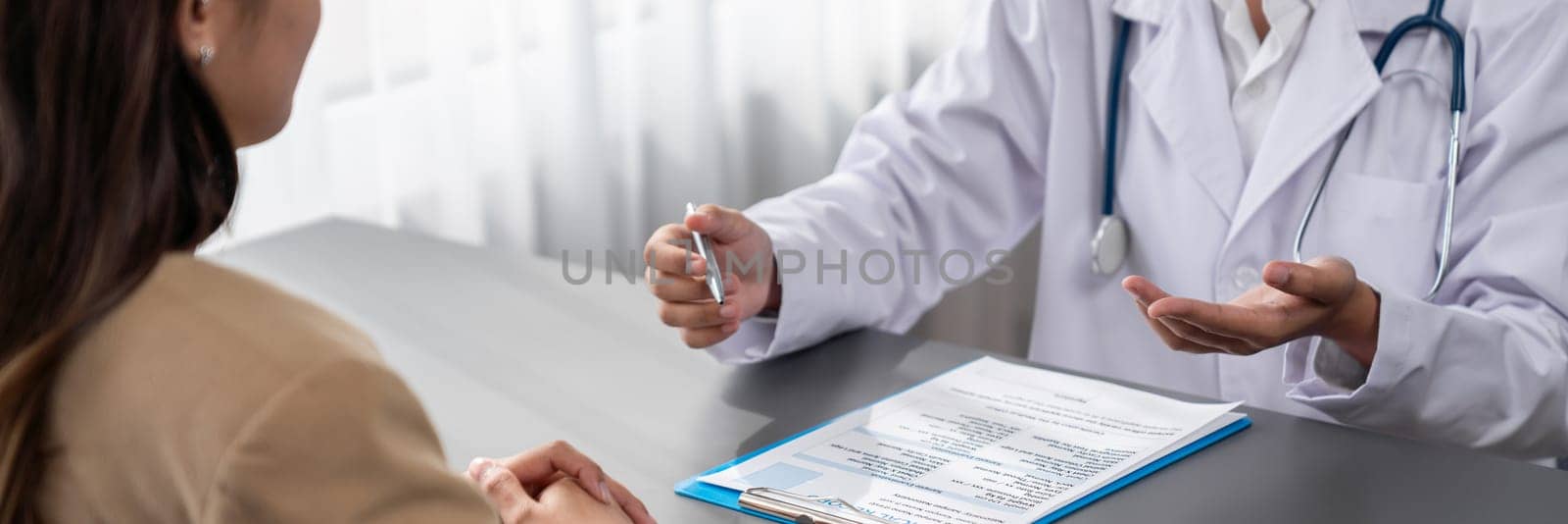Doctor show medical diagnosis report and providing compassionate healthcare consultation to young patient in doctor clinic office. Doctor appointment and medical consult concept. Neoteric