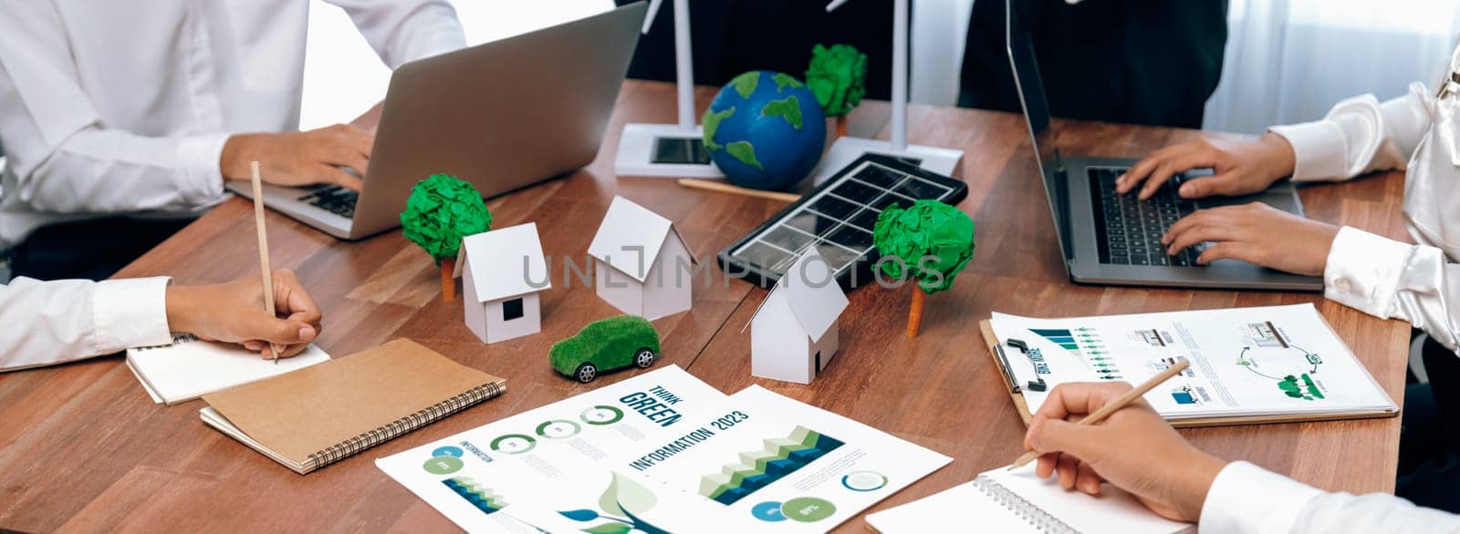 Eco business company meeting with group of business people planning strategy and discuss marketing of eco-friendly and renewable clean energy products. Green business company concept. Trailblazing