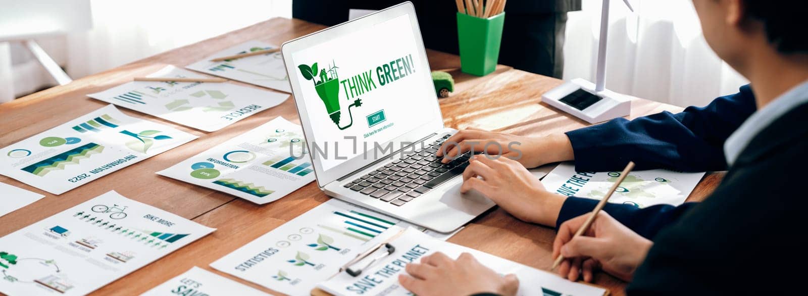 Business people in green corporate company planning eco-friendly and environmental conservative to reduce CO2 and implement net zero policy in meeting room with eco idea on laptop screen. Trailblazing