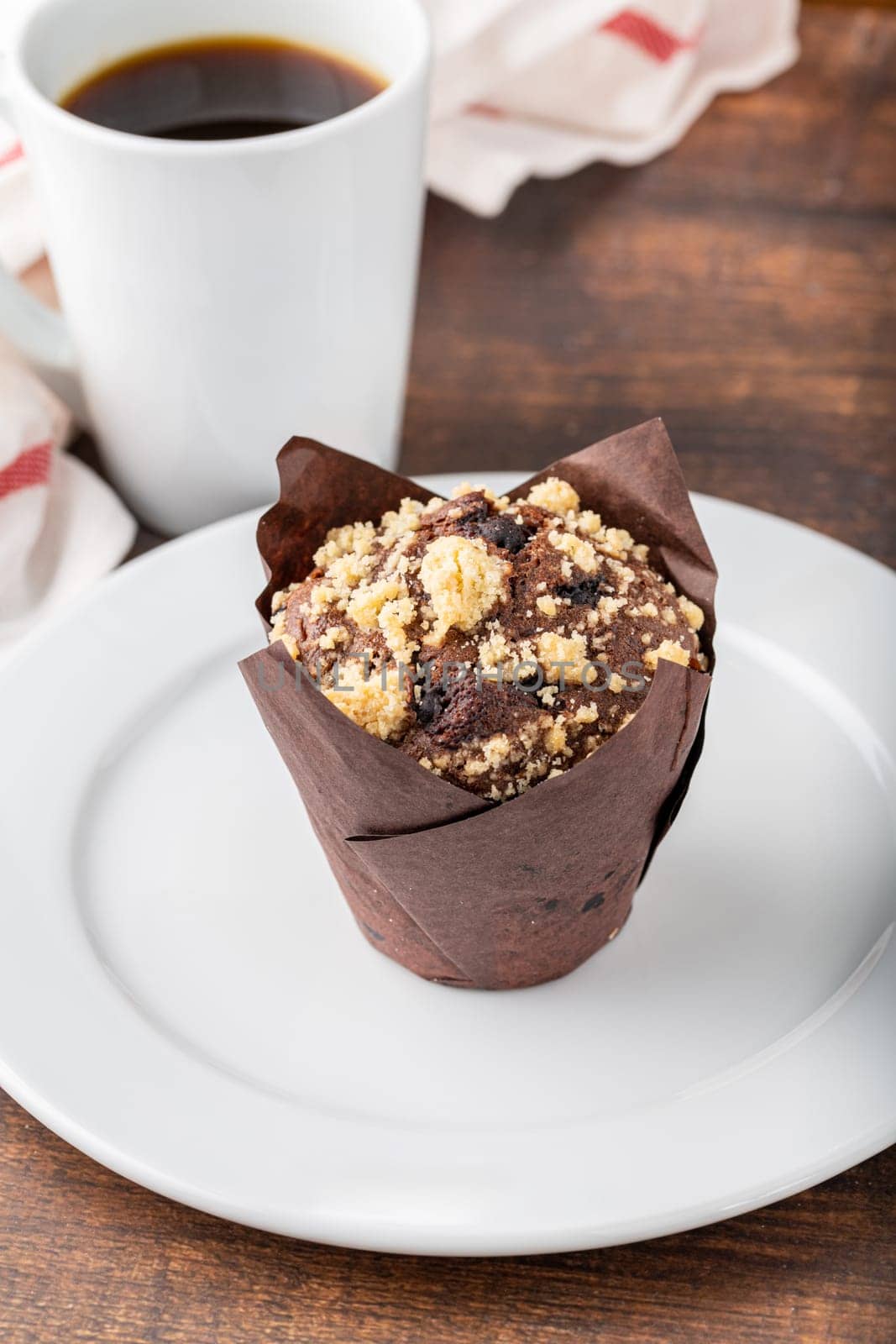 Chocolate muffin or cupcake with coffee on wooden table by Sonat