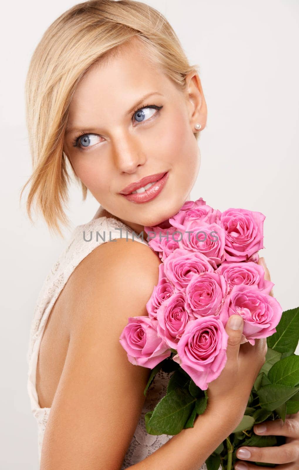 Flowers, bouquet and rose with woman in studio for floral, valentines day and romance gift. Plants, beauty and happy with face of female person on white background for elegant, love and present.