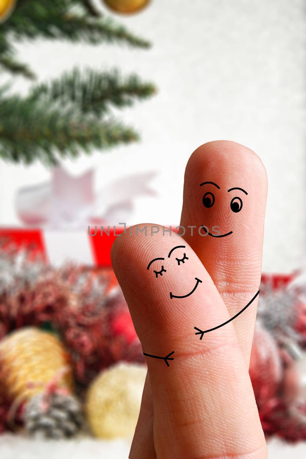 Faces of fingers hugging each other isolated on Christmas decorated background. Happy family celebrating Christmas day concept