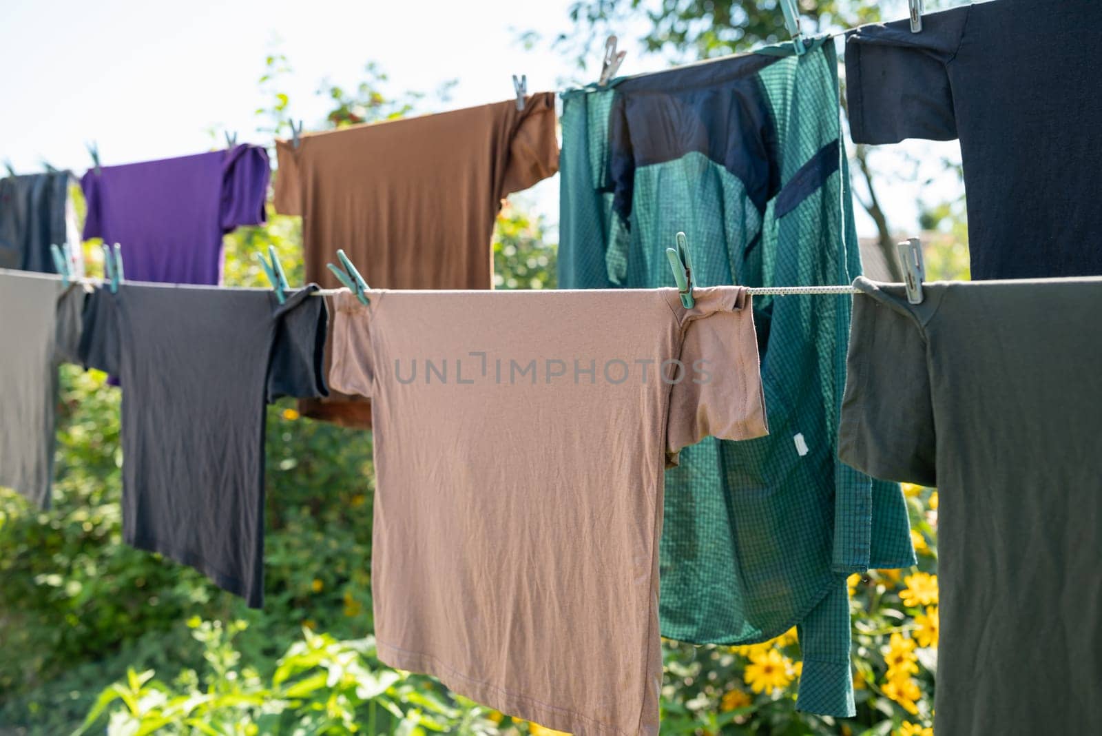 Male T-Shirts, doing laundry, washing clothes in the countryside