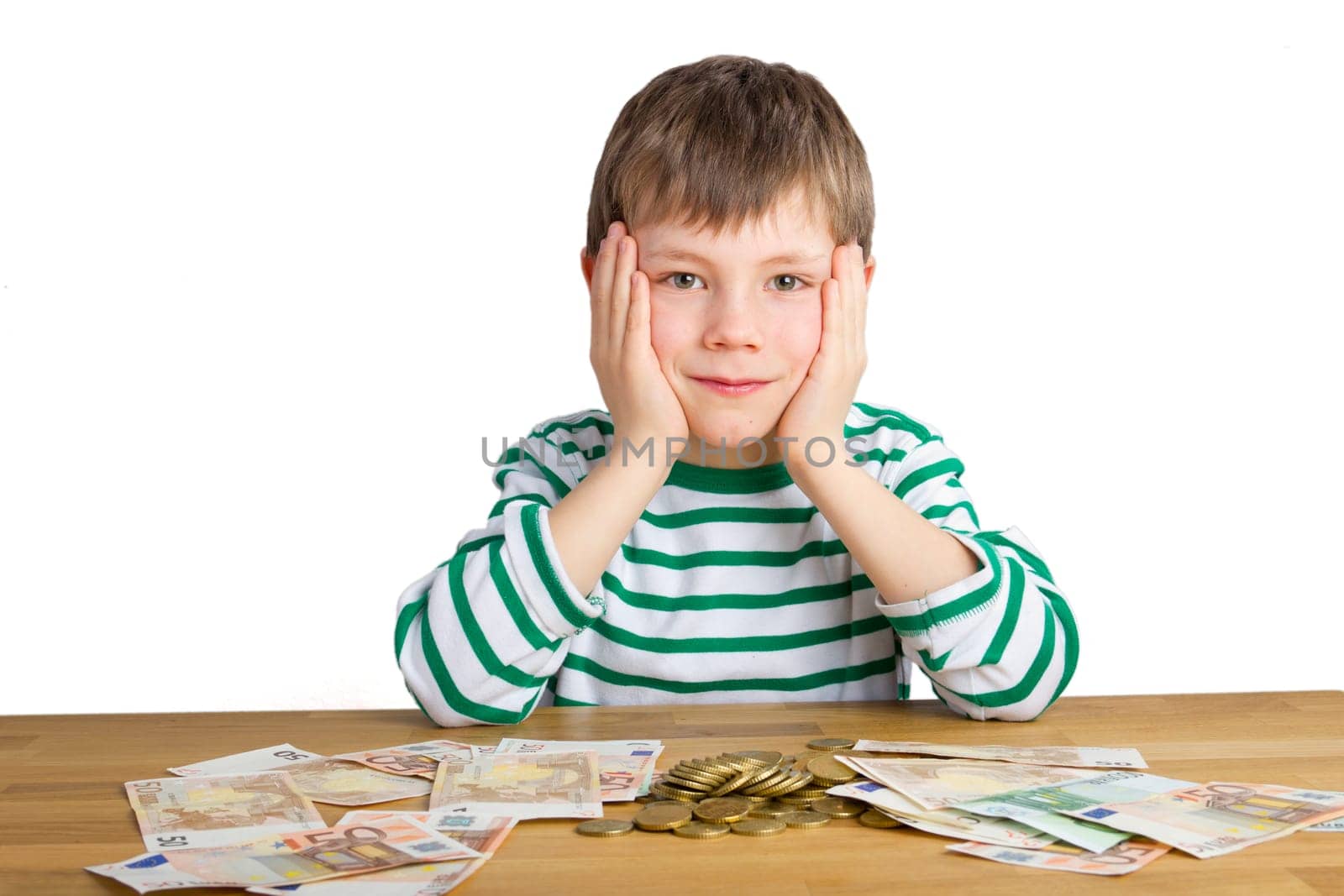 Boy sitting in front of coins and bills