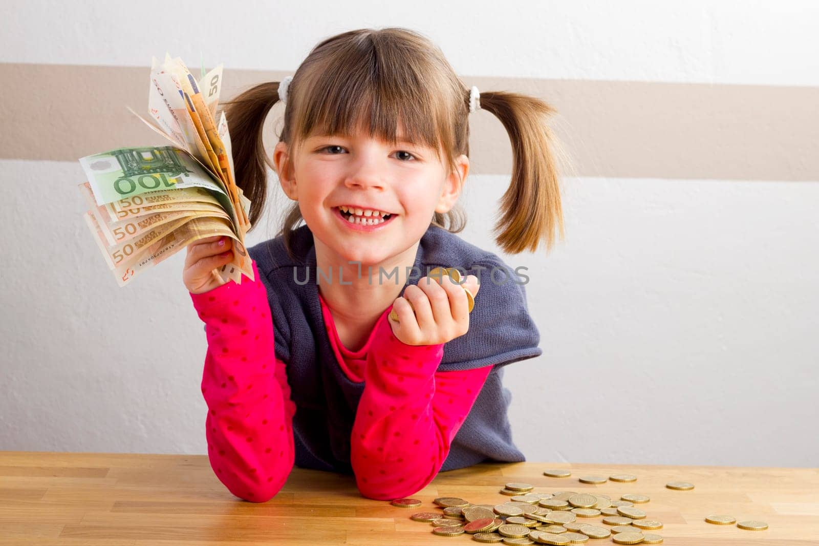 Child is happy about a lot of money