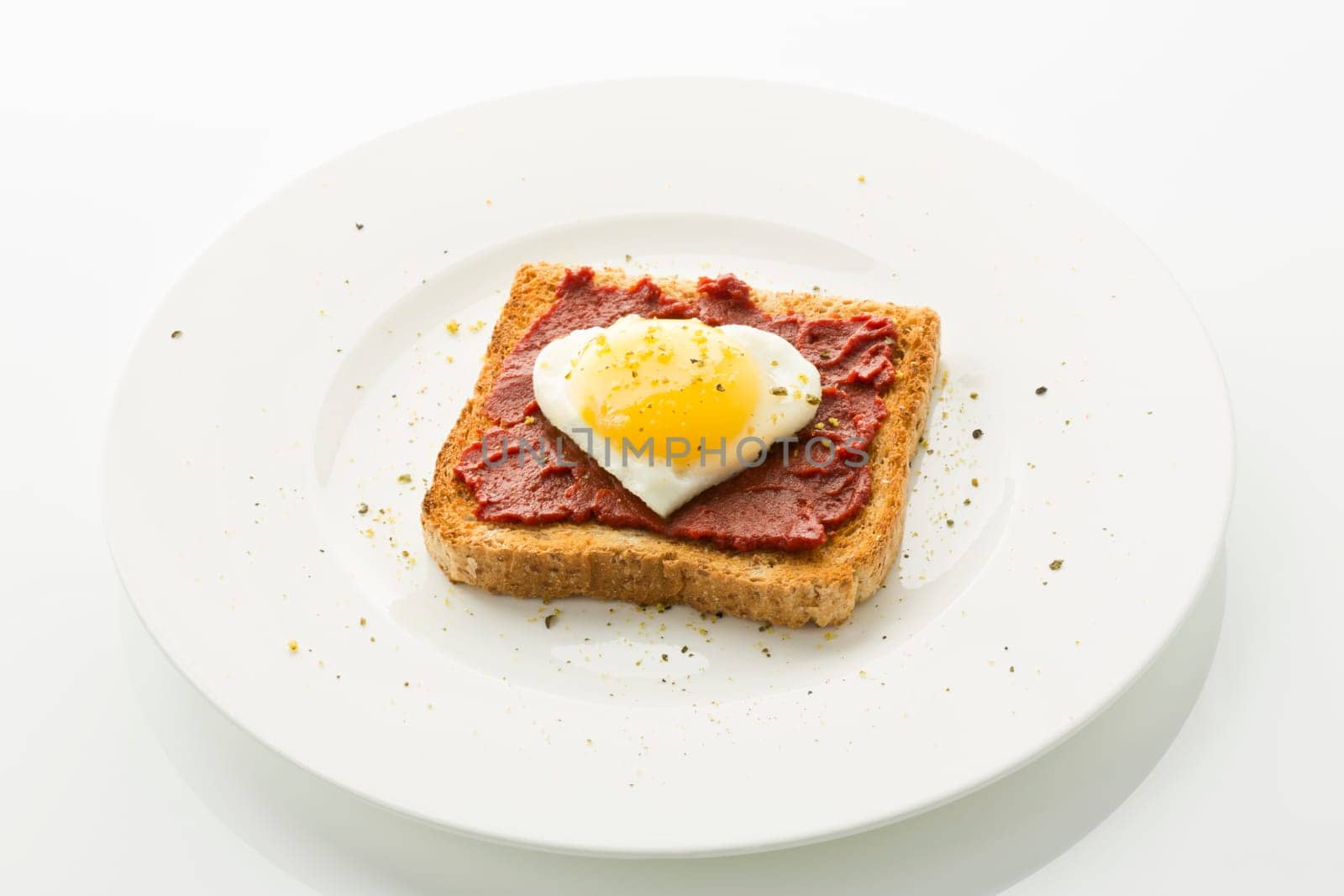 Fried egg heart on toast