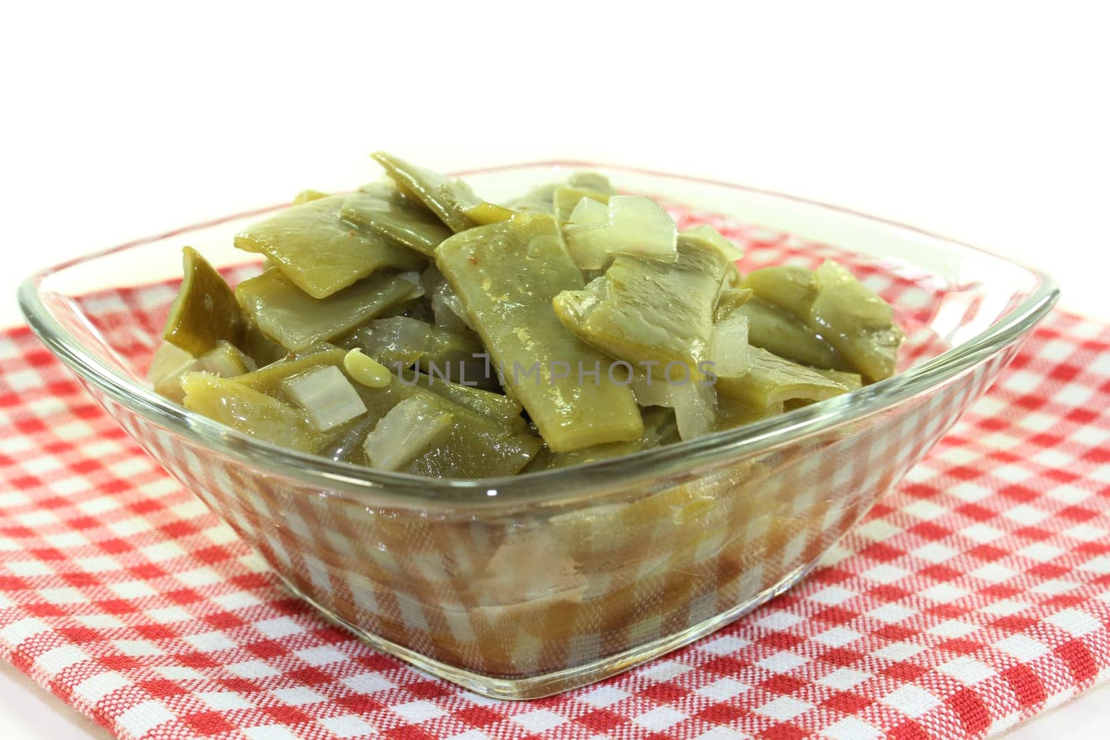 a bowl of bean salad against a white background
