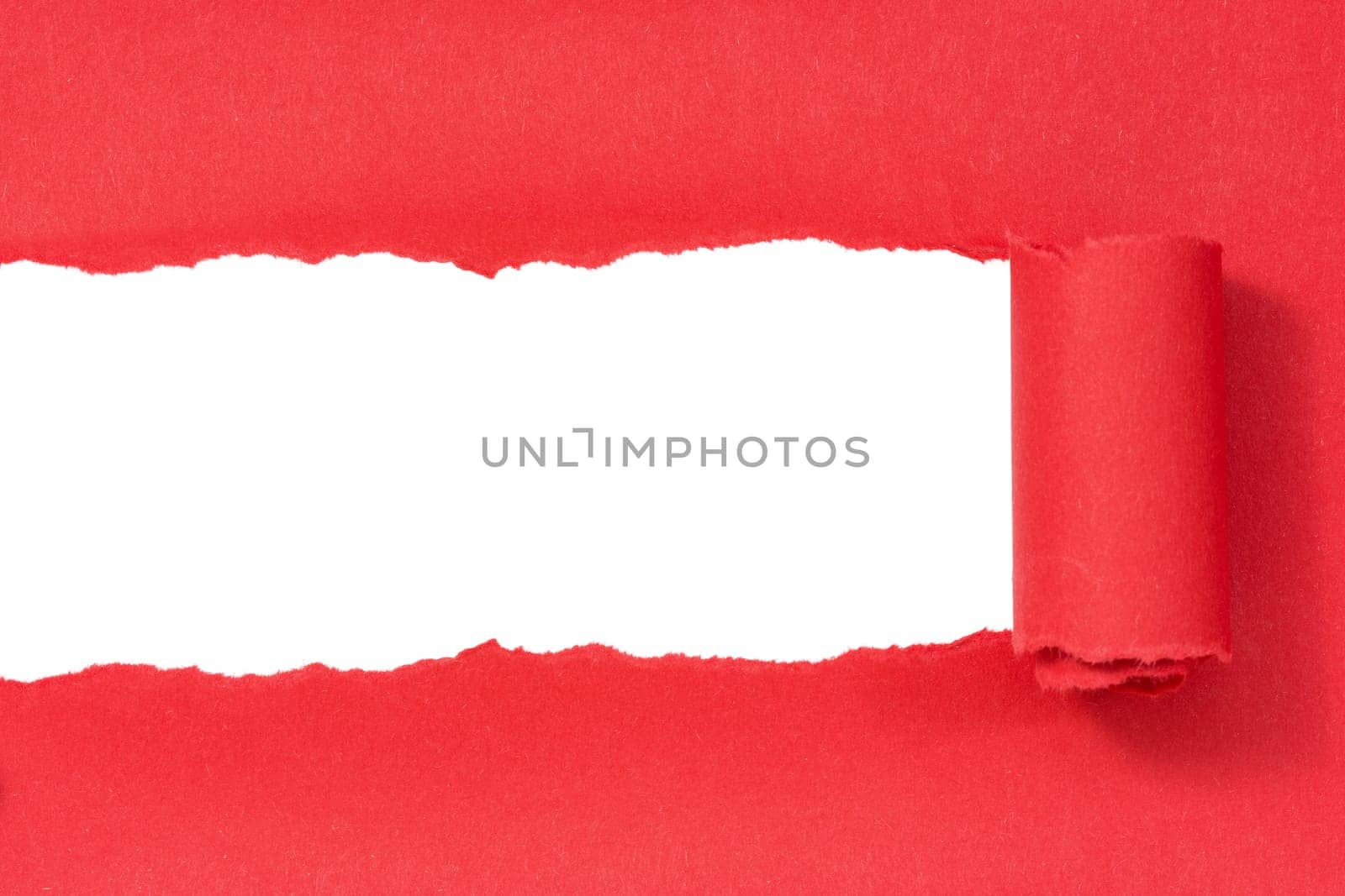 Red paper torn to reveal white panel ideal for copy space
