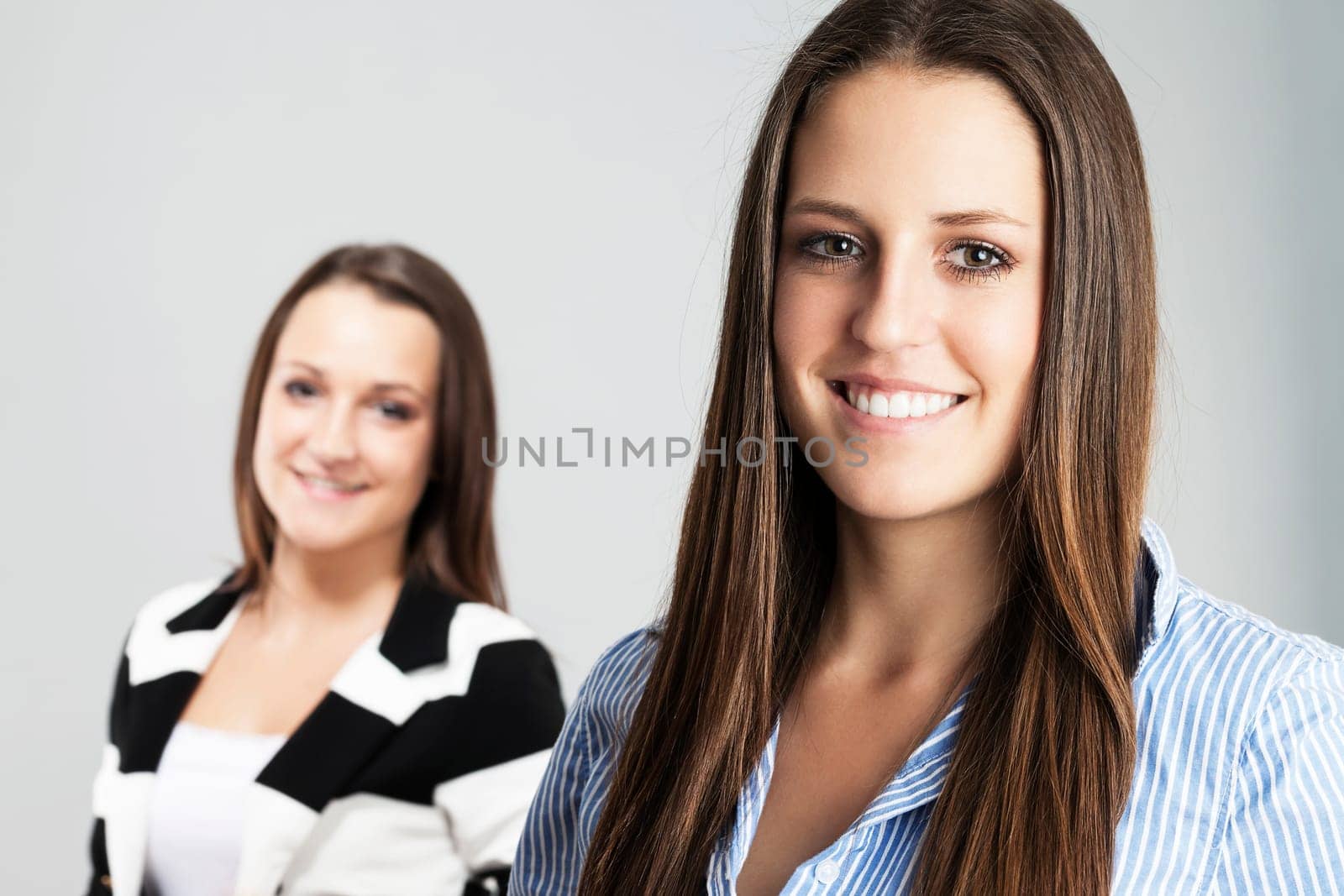 Portrait of a happy female teenager in front of her girlfriend