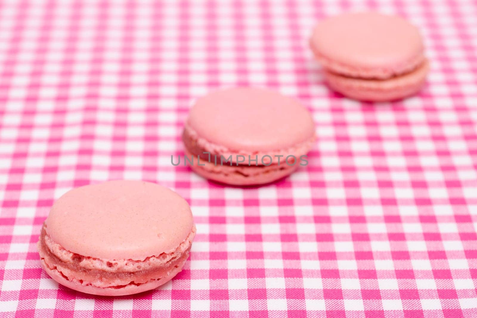Three macararons with strawberry filling