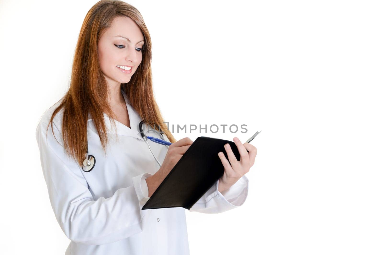 Pretty female doctor isolated writing in a Planner