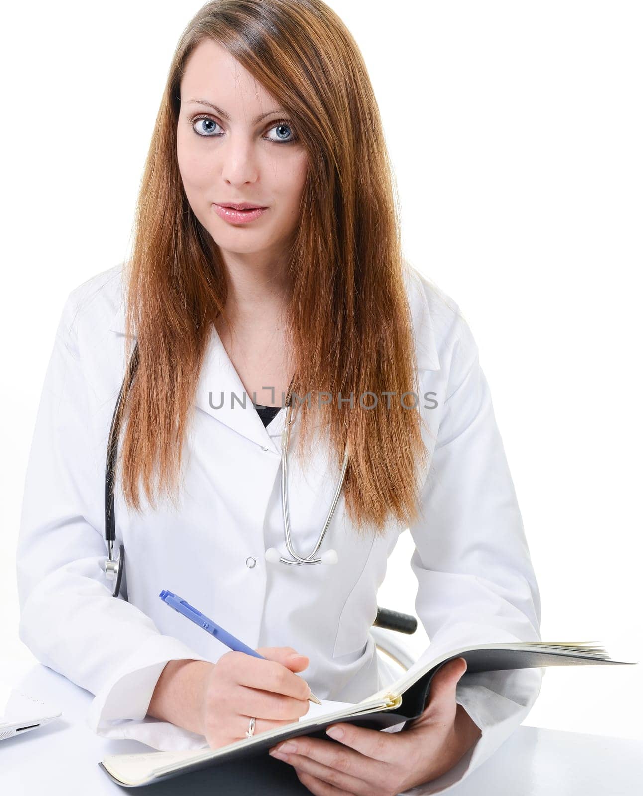 Pretty female doctor isolated writing in a Planner