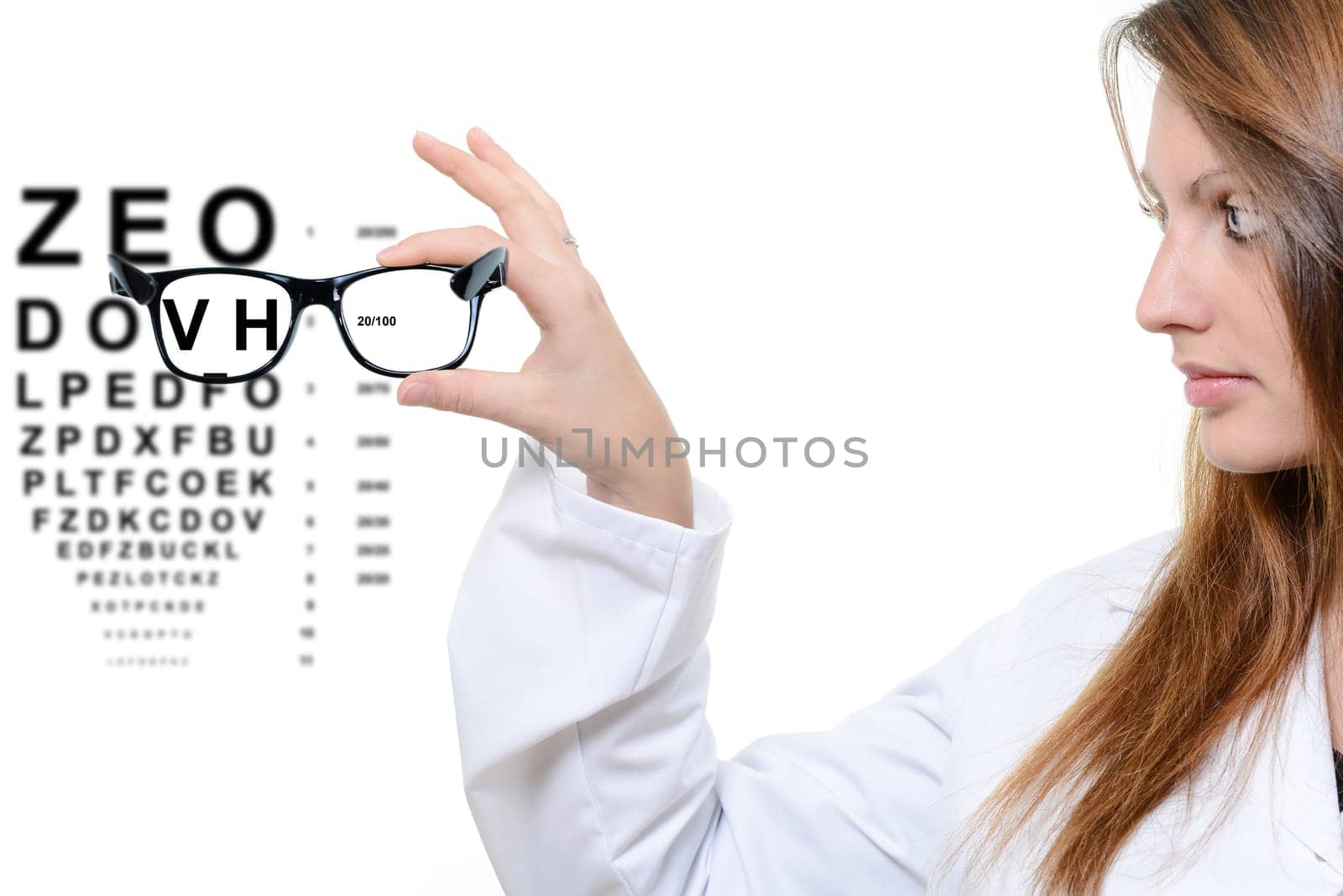 Woman with glasses and snellen eye chart in background