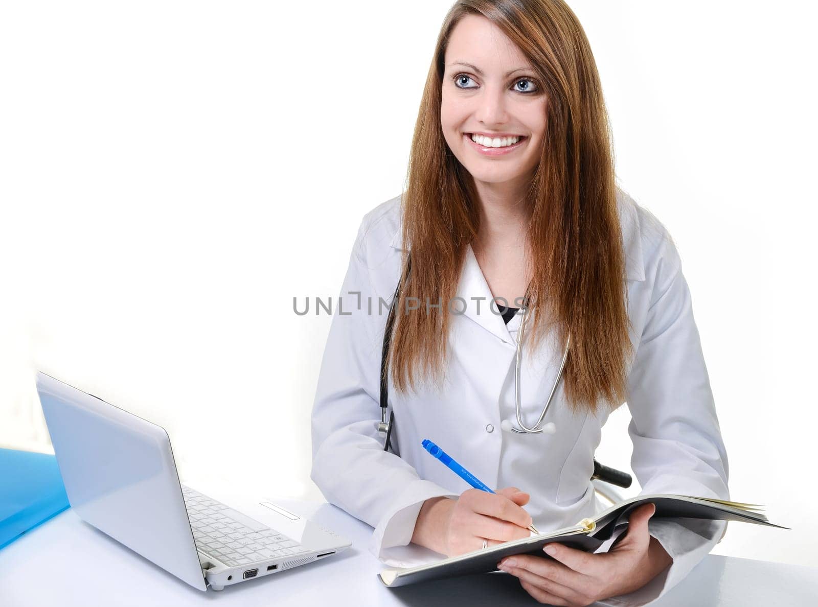 Pretty female doctor isolated writing in a Planner