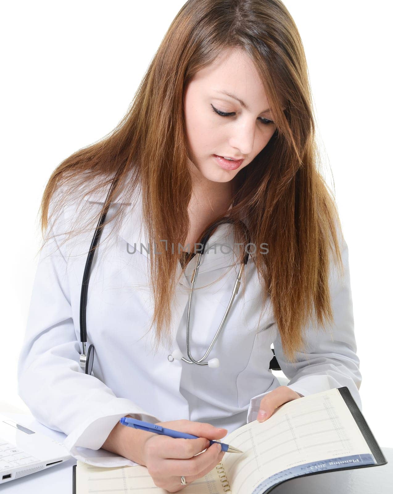 Pretty female doctor isolated writing in a Planner
