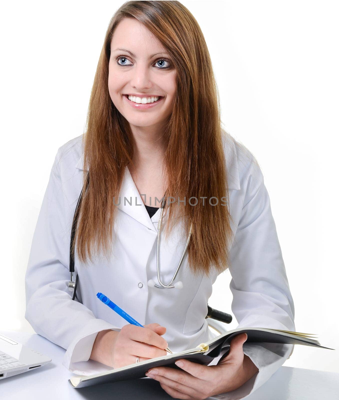 Pretty female doctor isolated writing in a Planner