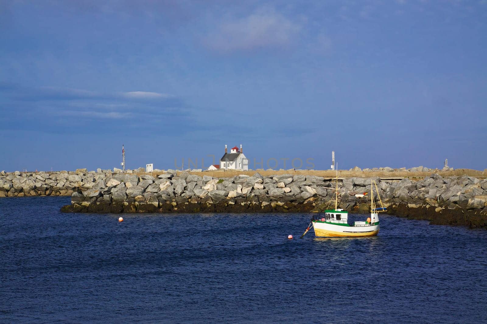 Traditional norwegian fishing boat in harbor on island of Vaeroy, Lofoten in Norway