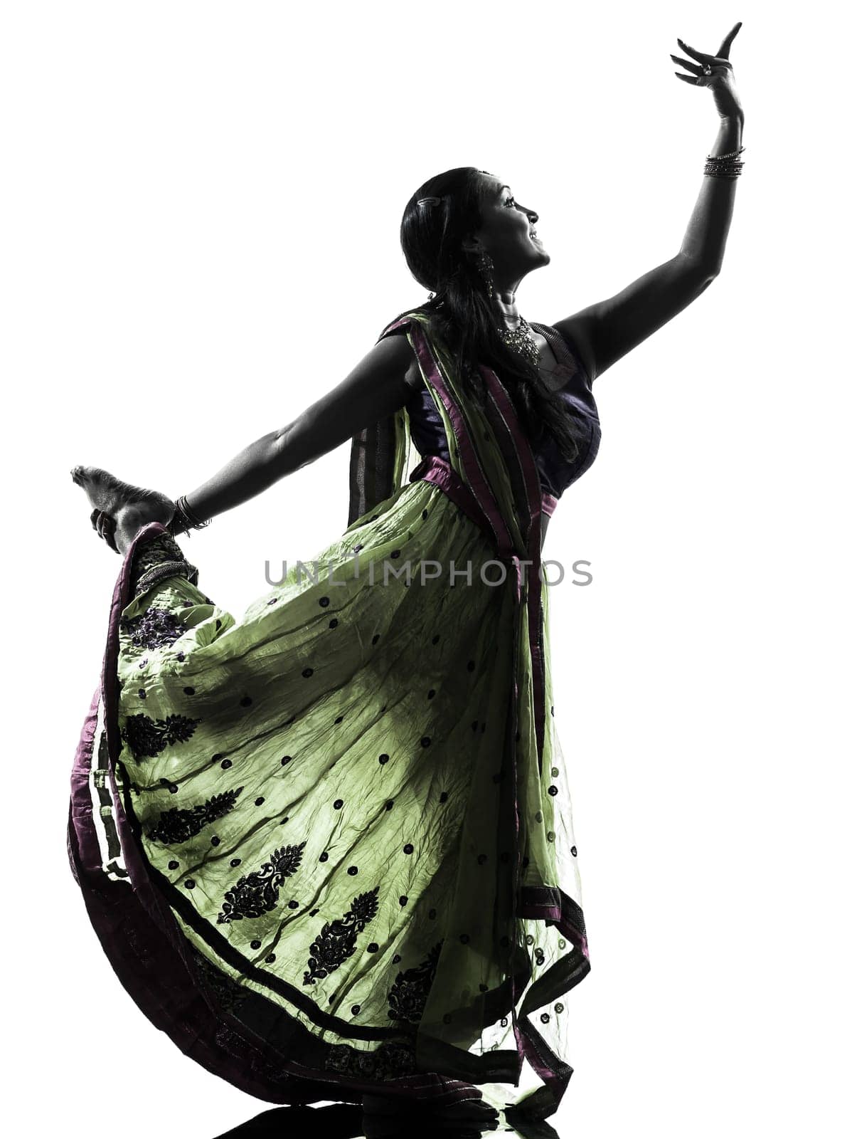 one indian woman dancer dancing in silhouette studio isolated on white background
