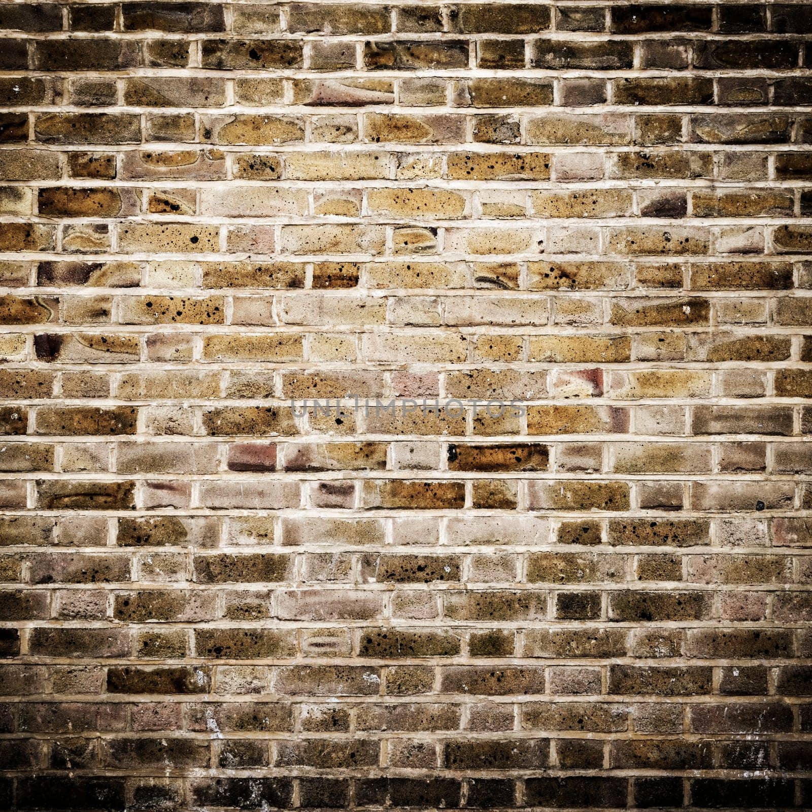 Grunge brick wall, square photograph with vignette