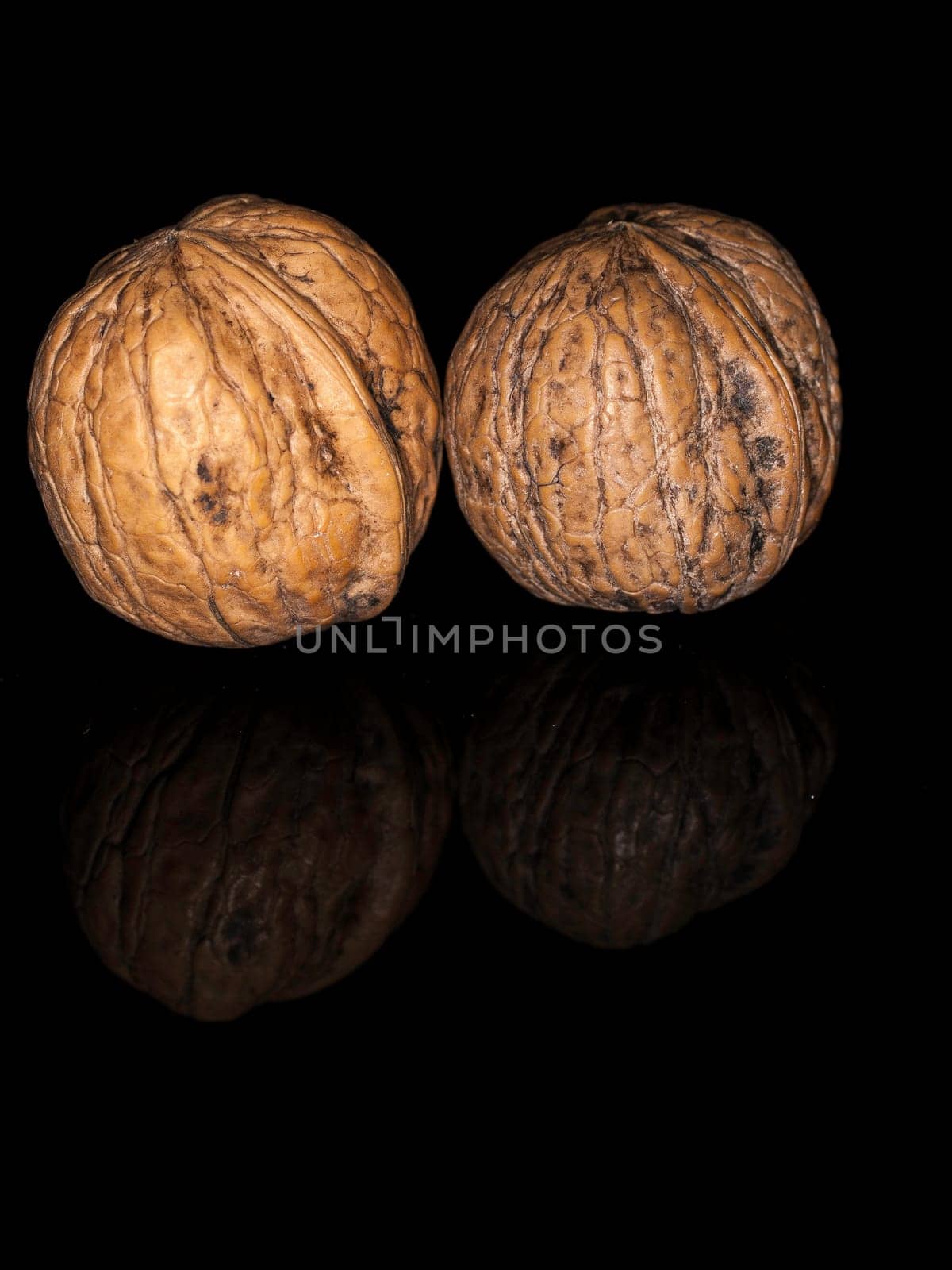Two walnuts on Black background