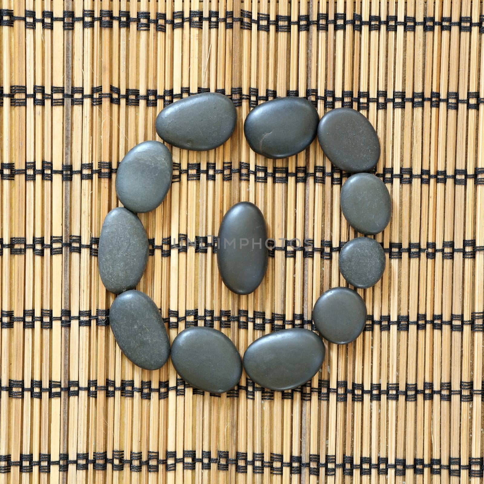Details of a tranquil scene, made with black pebbles in a circle
