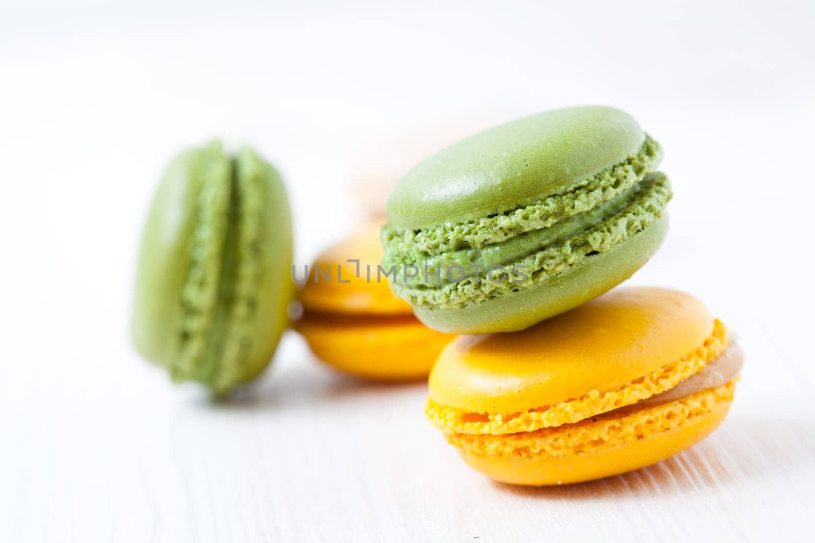 Close-up of colorful macaroons on light background