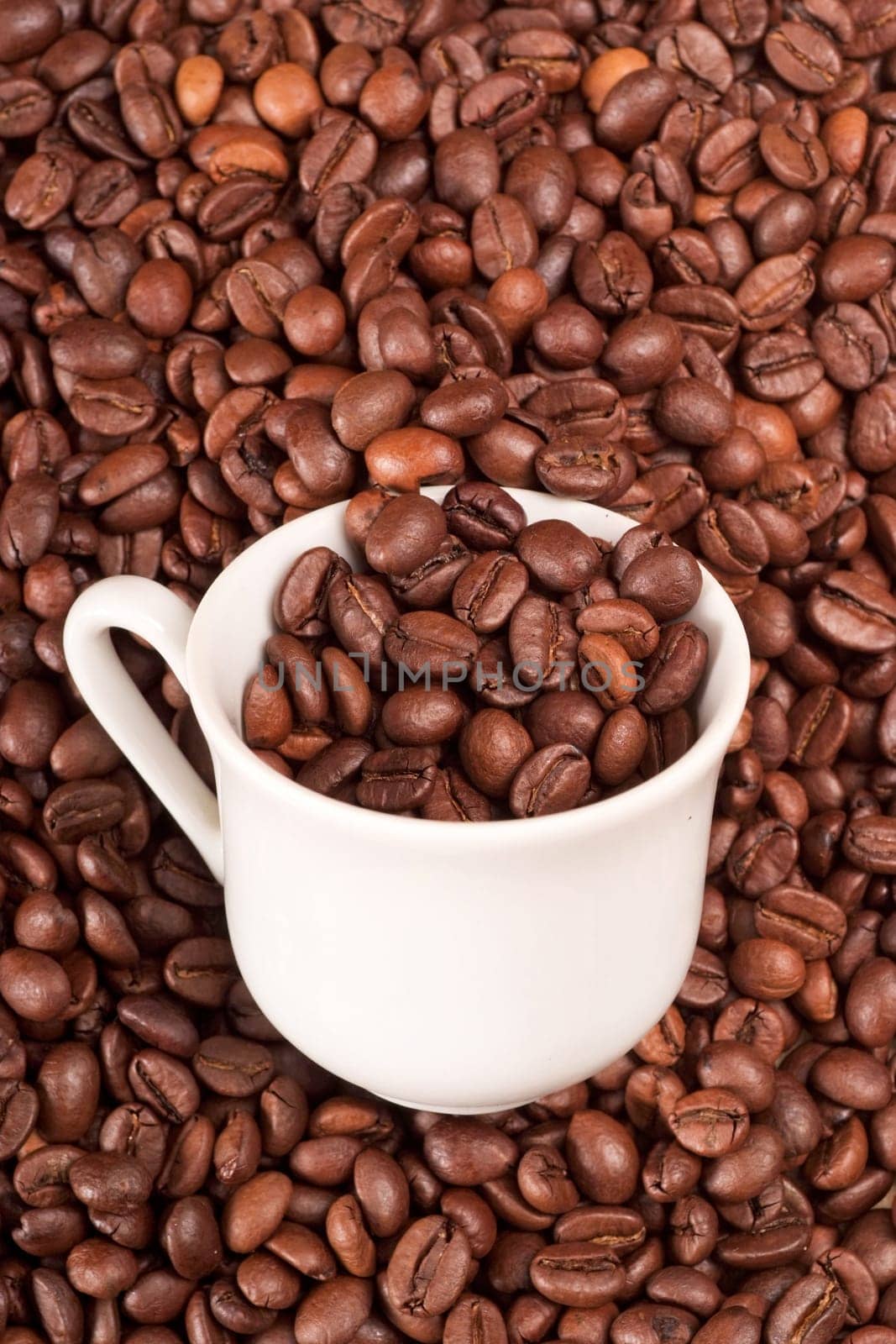 White cup filled with coffee beans