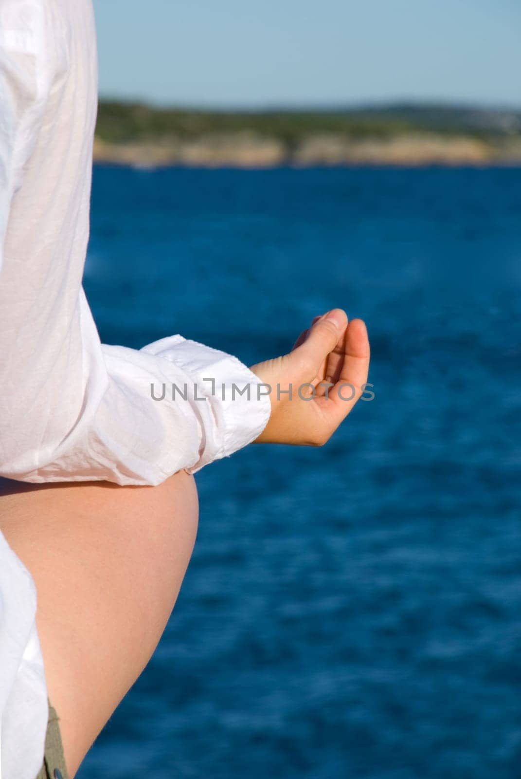 a cutout of a woman doing yoga at the coast