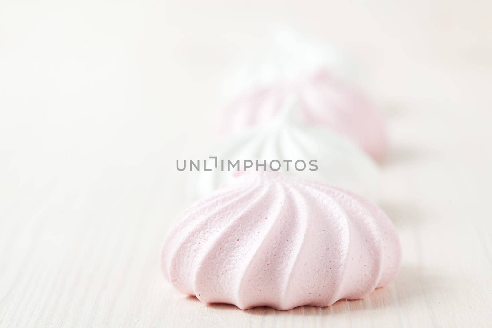 Row of meringues on light background