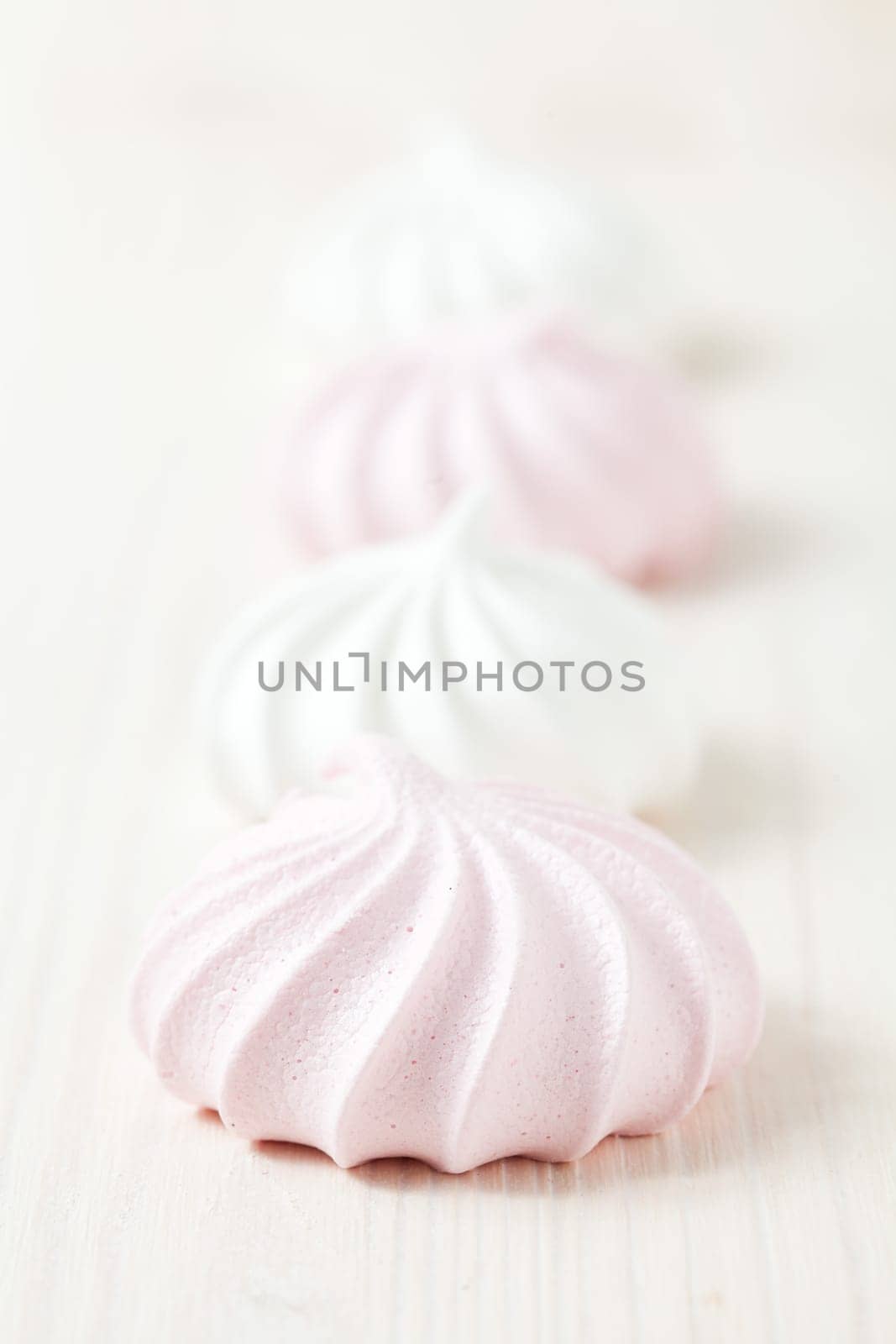 Row of meringues on light background